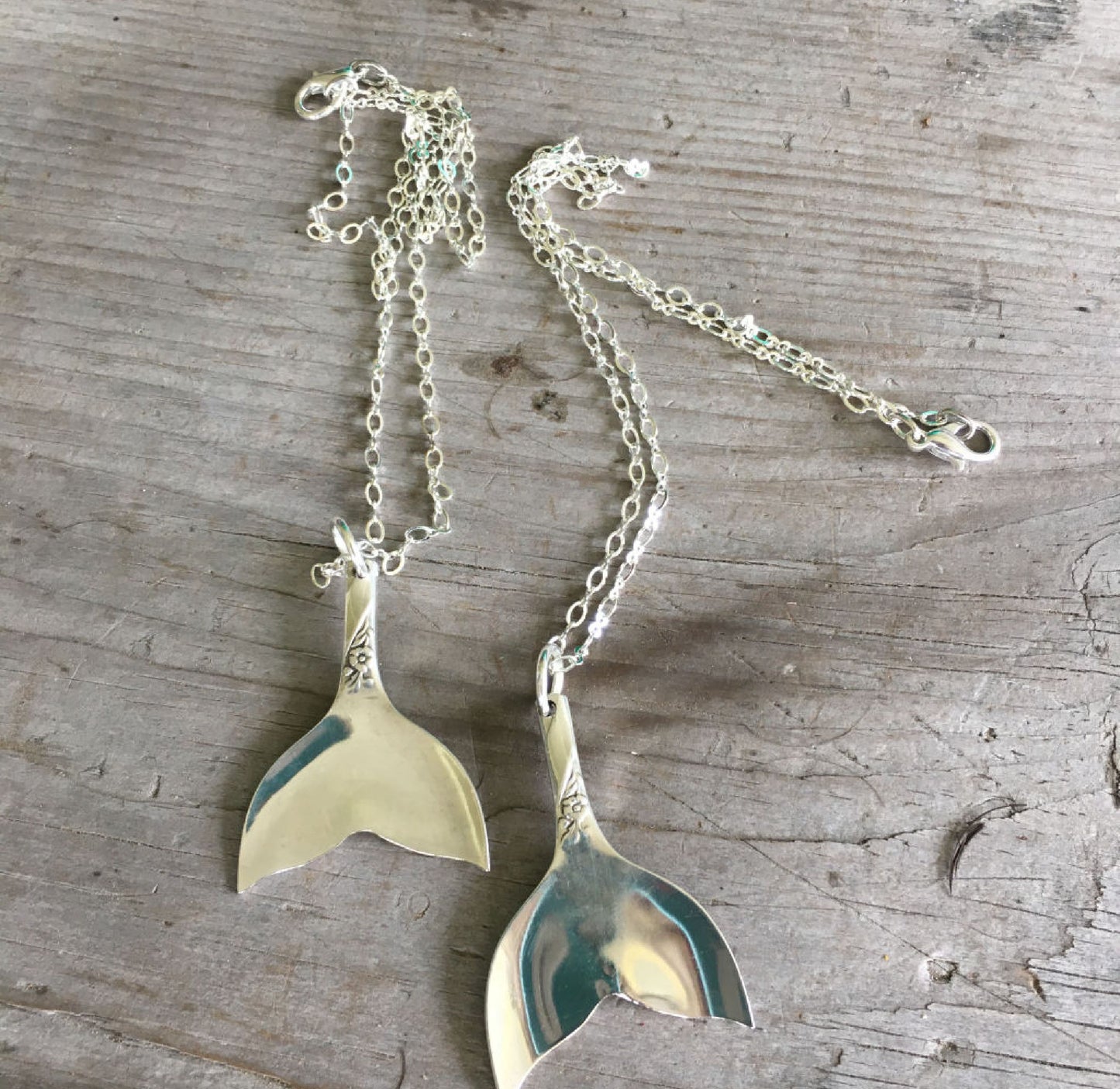 Handmade upcycled silverware spoon necklaces in the shape of a tail fin