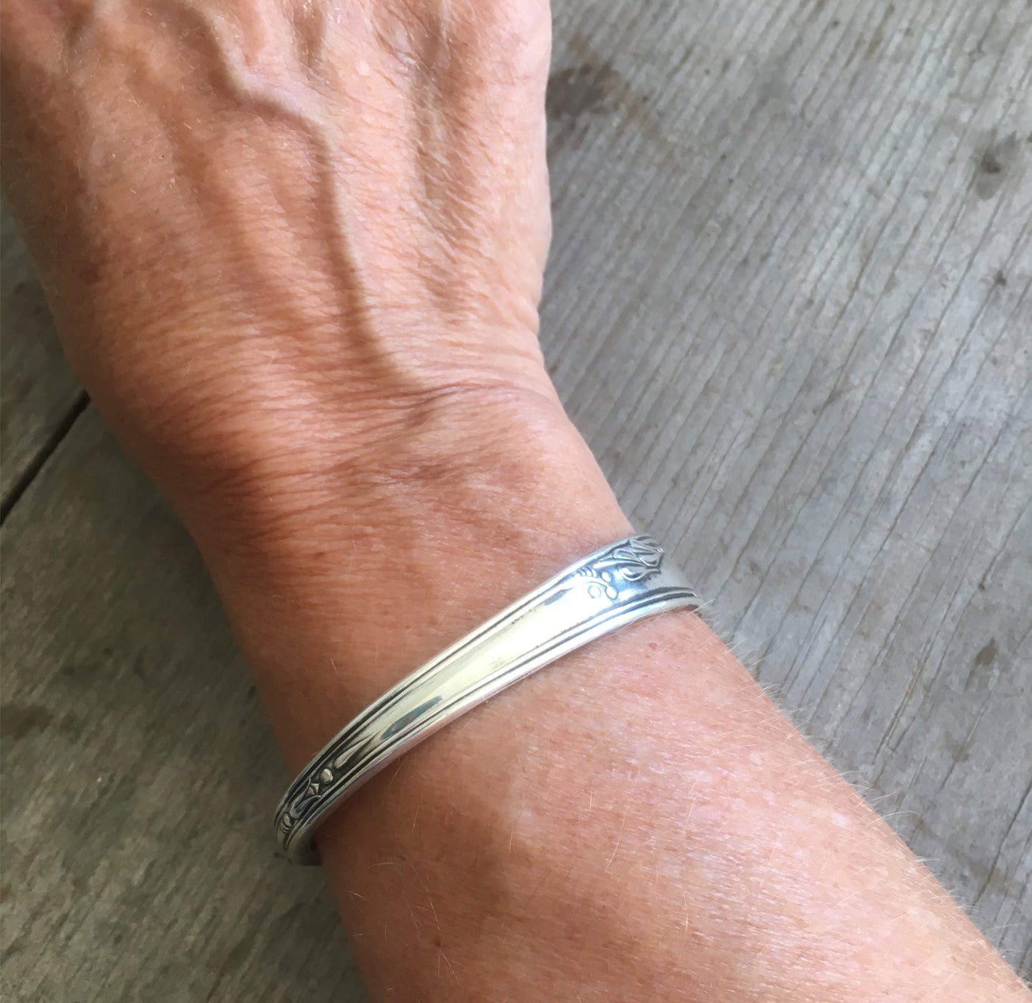 Hand Stamped Spoon Cuff Bracelet Lead with Love Shown on Model
