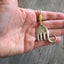 Handmade Fork Elephant Necklace Shown in hand for scale