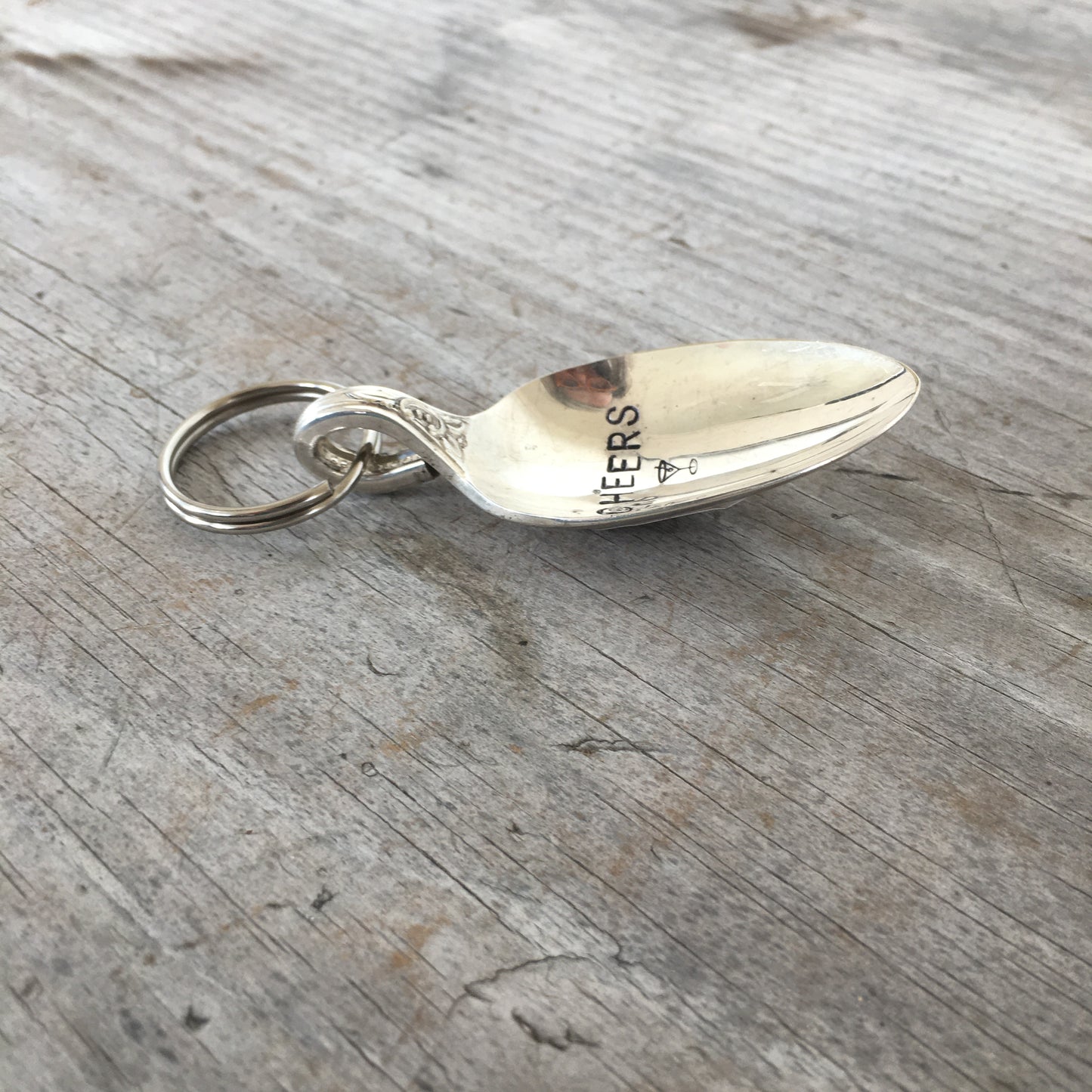 Close-up side view of Cheers martini hand-stamped spoon keychain showing vintage silverware detail and cocktail glass