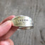 Close up of hand stampin on BADASS Spoon bracelet