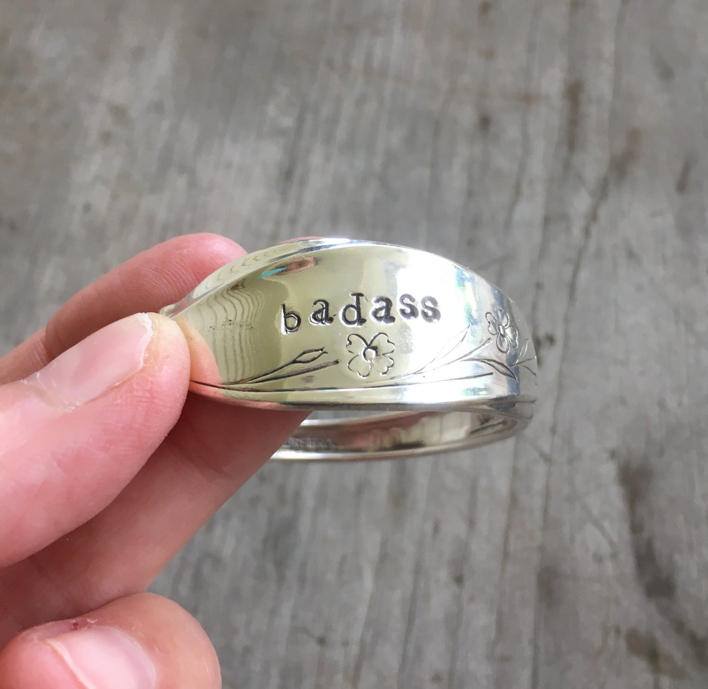 Close up of hand stampin on BADASS Spoon bracelet