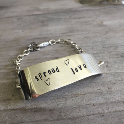 Handcrafted Spread Love hand-stamped knife bracelet with heart charm - premium upcycled vintage silverware artisan jewelry