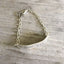 Close-up of Spread Love hand-stamped message on vintage knife bracelet - eco-friendly upcycled silverware artisan jewelry