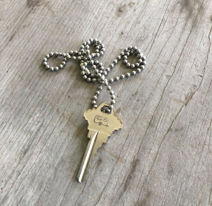 Hand stamped giving key necklace with airstream camper