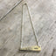 Close-up detail of VOTE bar pendant showing hand-stamped lettering on vintage Ambassador pattern silverware, 2.125 inches wide