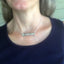 Upcycled silverware bar Necklace Hand Stamped Vote shown on model