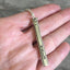 Upcycled silverware Necklace Hand Stamped Vote shown in hand for scale