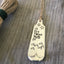 Closeup of Oh the Places You'll Go by Dr. Seuss Hand Stamped Upcycled Silverware bookmark with tassel