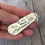 Close-up of Oh The Places You'll Go hand-stamped lettering on vintage spoon keychain upcycled silverware