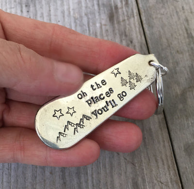 Close-up of Oh The Places You'll Go hand-stamped lettering on vintage spoon keychain upcycled silverware