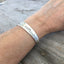 Handmade Spoon Bracelet Stamped BADASS shown on model