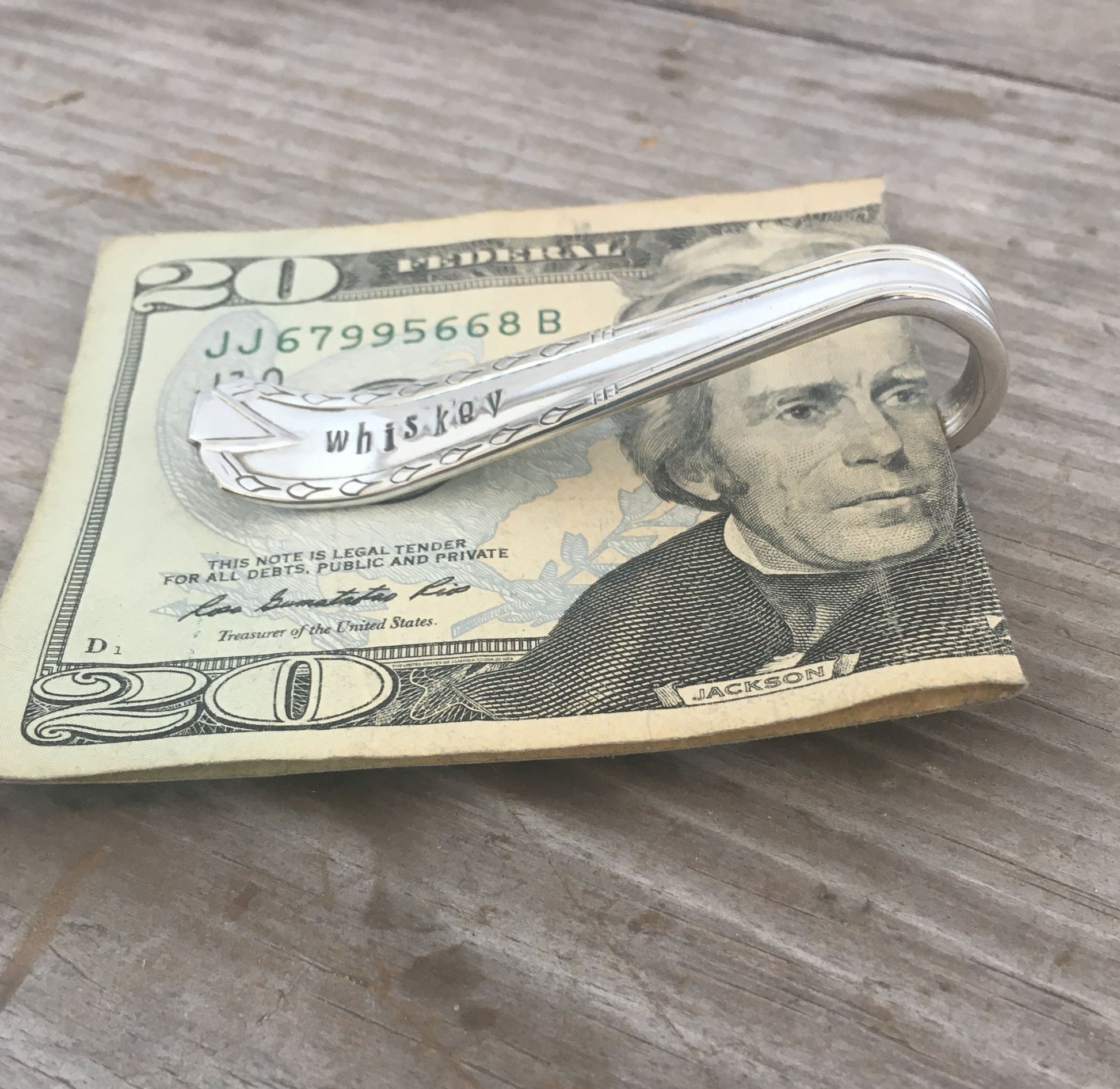 Side view of spoon money clip hand stamped WHISKEY