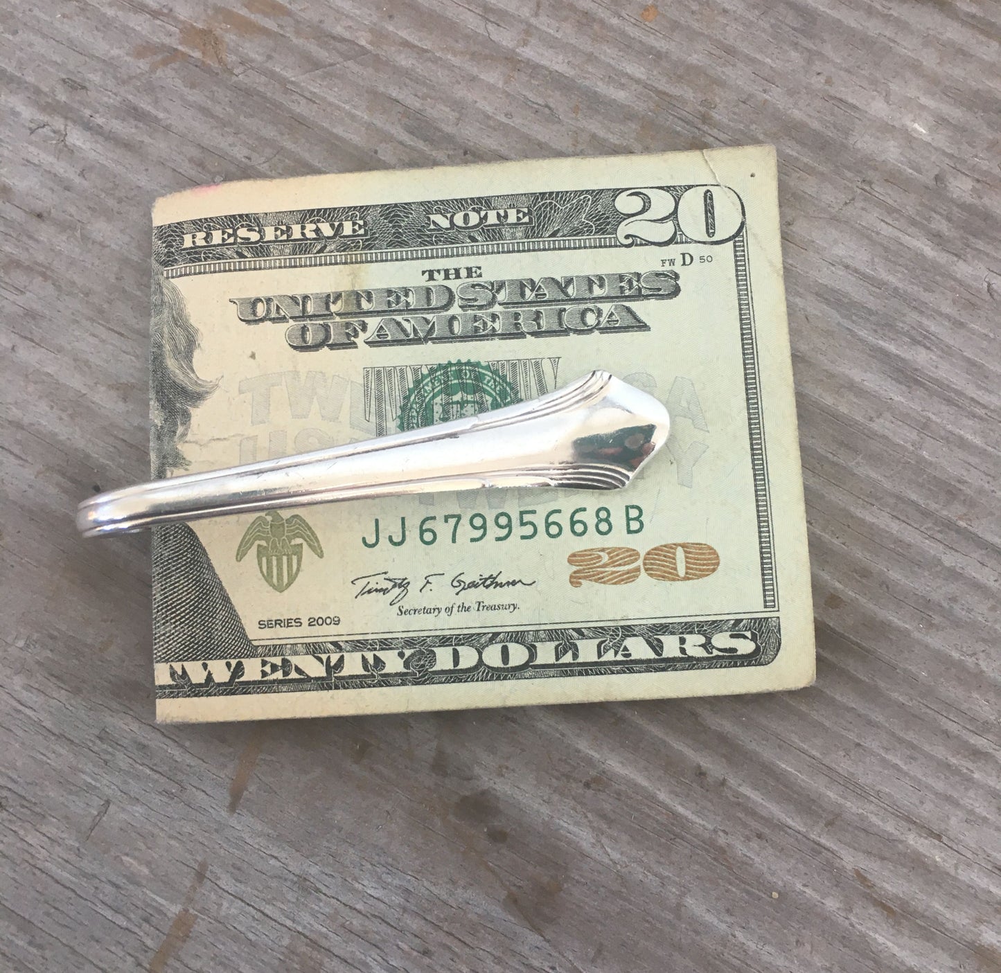 Back view of handcrafted spoon guitar money clip MOJO showing silverplate detail