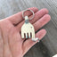 Upcycled silverplate fork elephant keychain charm with personality and vintage patina, one-of-a-kind handmade design shown in hand for scale