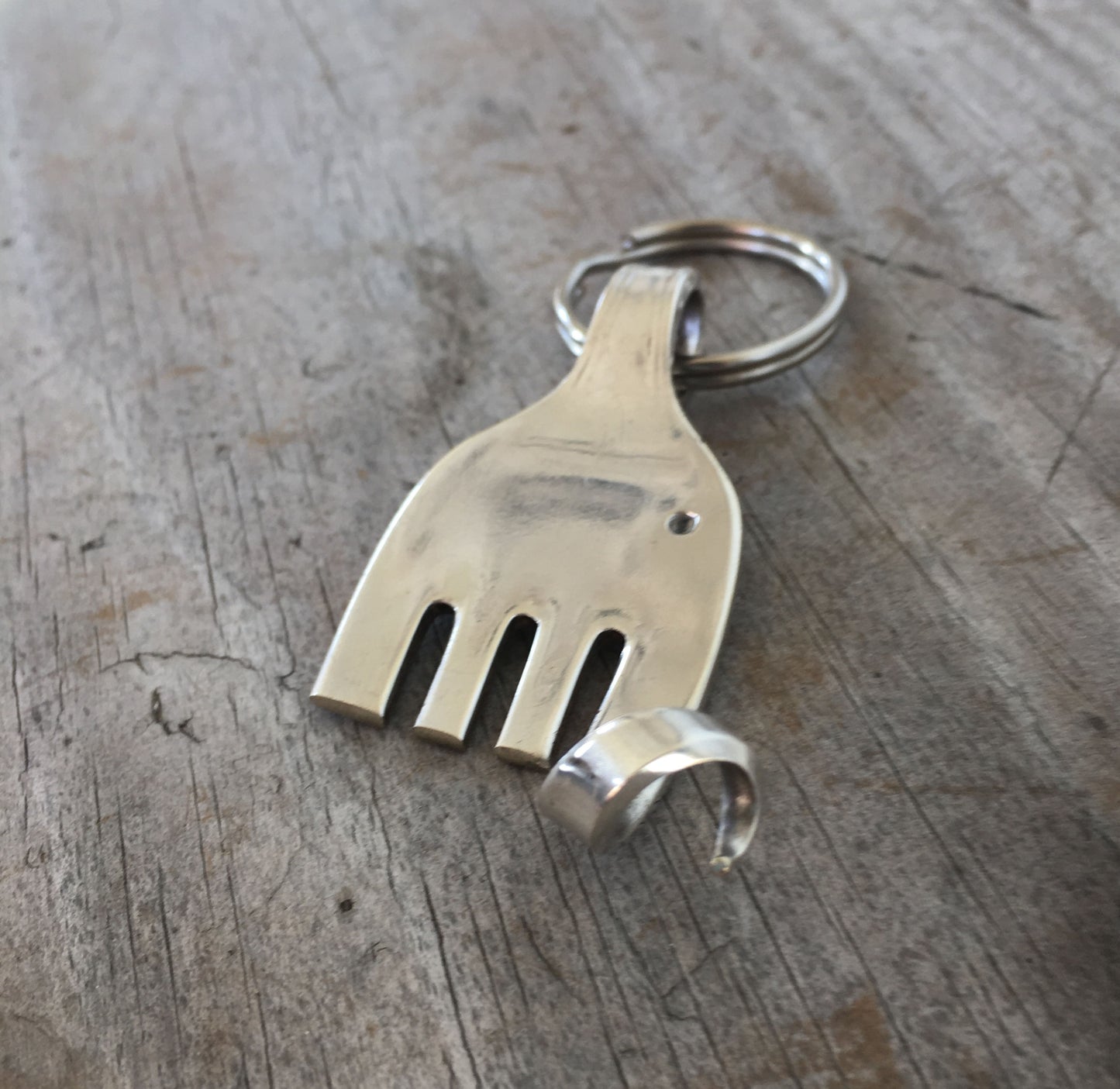Handcrafted fork elephant keychain with curled trunk made from upcycled vintage silverplate flatware