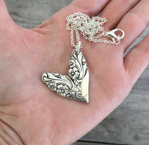 Upcycled Spoon Handle Heart Pendant Shown in Hand for Scale