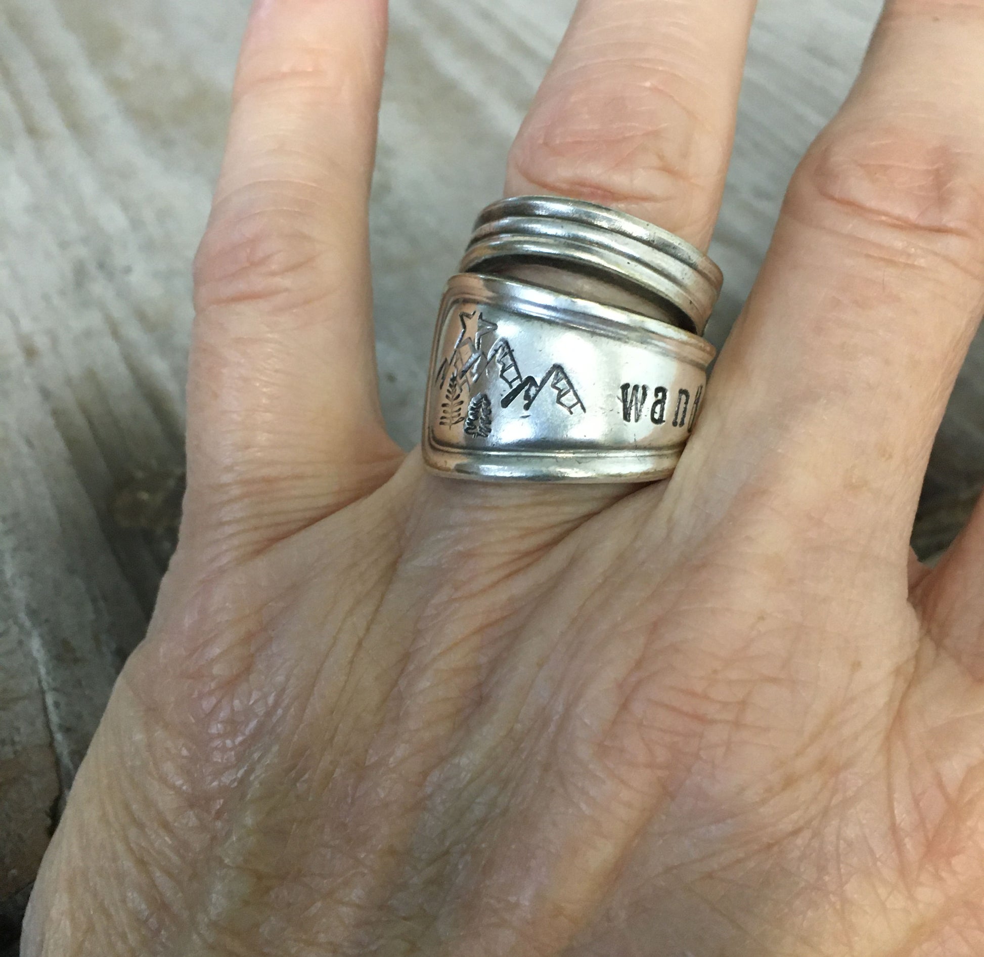 Wander mountain spoon ring shown on hand - handcrafted artisan silverware jewelry