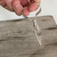 Side view of exclusive handle design on Front Angle view of ergonomic cheese knife made from an upcycled vintage spoon