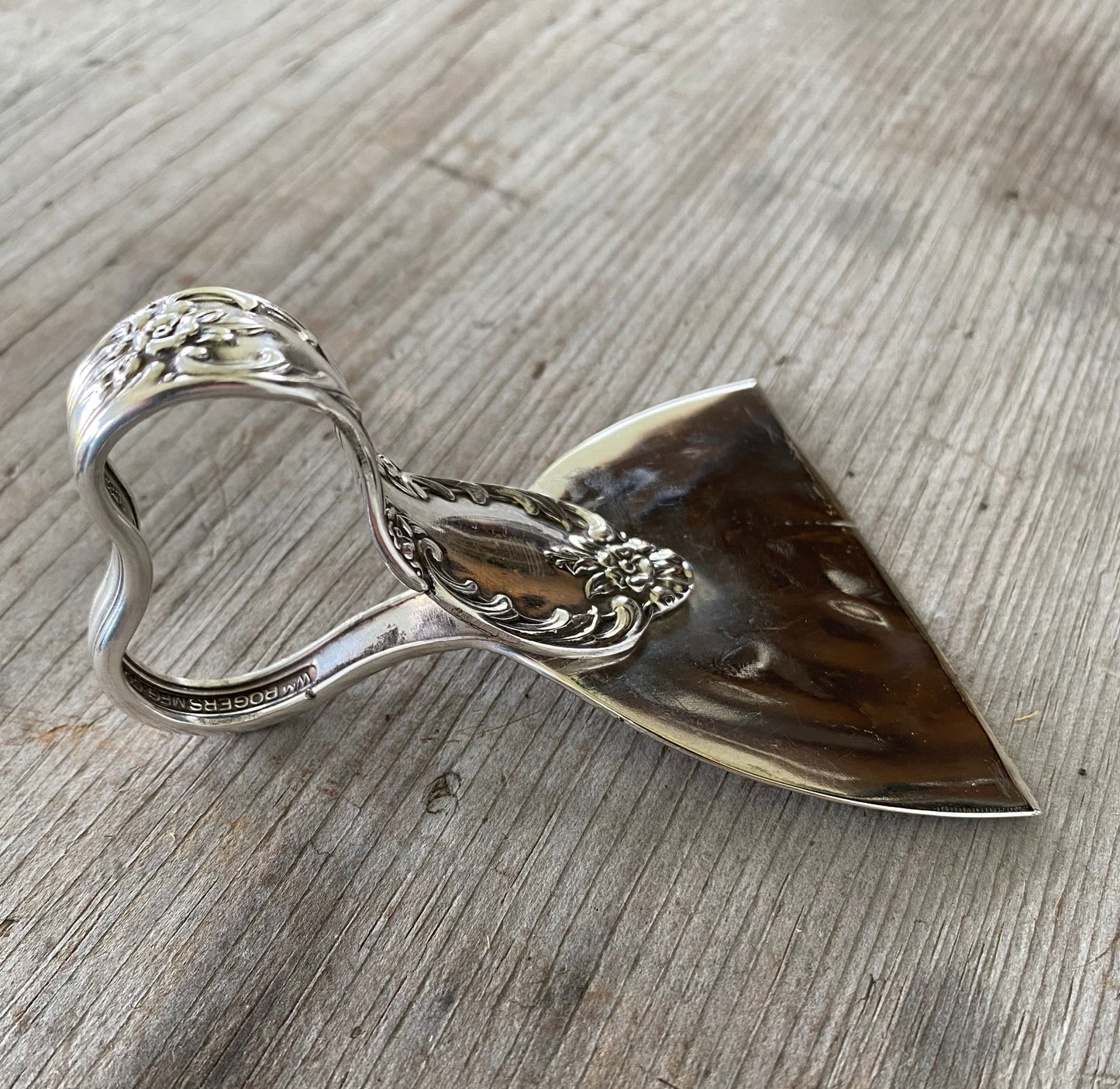 Side view and handle detail of ergonomic cheese knife made from an upcycled vintage spoon