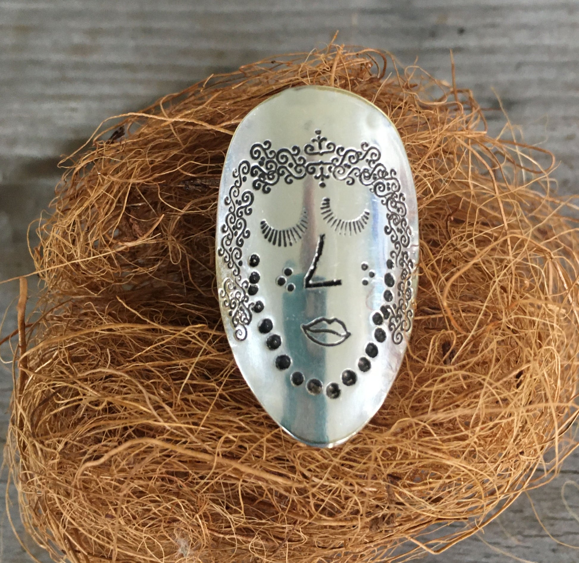 Close-up of Celeste Women of Nature hand-stamped spoon ring with celestial symbols - upcycled vintage silverware