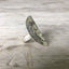 Side view of Women of Nature Celeste spoon ring showing hand-stamped woman's face and striped flower shank detail