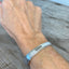 Upcycled silverware spoon cuff bracelet stamped BADASS shown on model