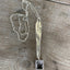 Close-up of FAMILY hand-stamped vintage silverware handle pendant showing Bridal Wreath pattern detail and swappable photo insert