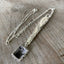 Detail of upcycled Tudor Plate silverware FAMILY necklace showing hand-stamped lettering and patchwork silverplate chain, one-of-a-kind jewelry