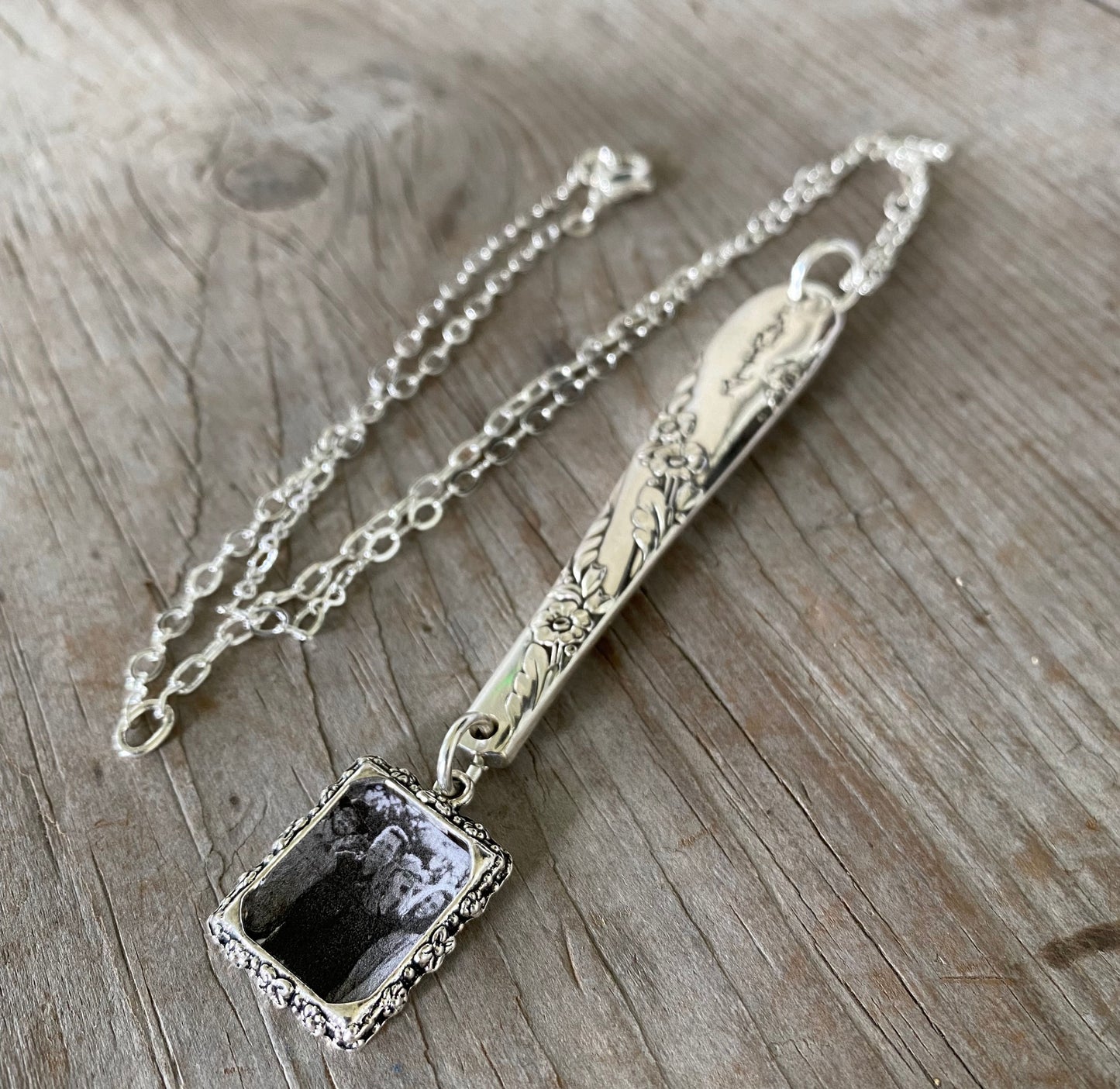 Detail of upcycled Tudor Plate silverware FAMILY necklace showing hand-stamped lettering and patchwork silverplate chain, one-of-a-kind jewelry