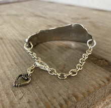 Focus on chain and heart charm on Spread Love Handstamped Upcycled Knife Bracelet