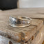 Hand-stamped spoon cuff bracelet from International Silver Cromwell pattern with WANDER message, mountains, trees and star design