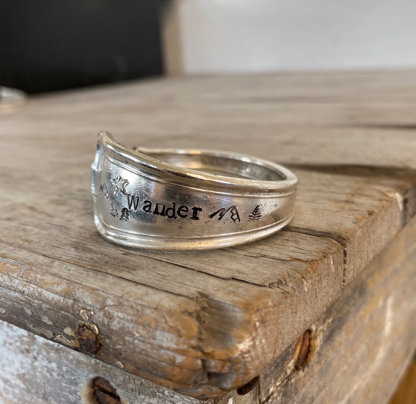 Hand-stamped spoon cuff bracelet from International Silver Cromwell pattern with WANDER message, mountains, trees and star design