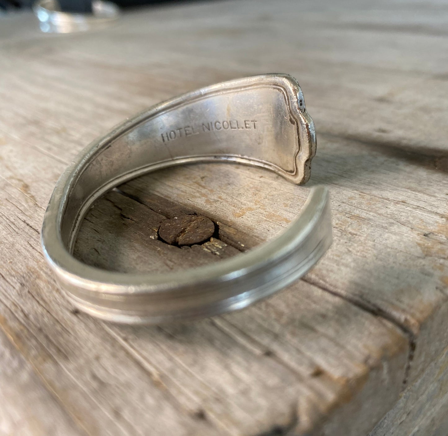 Close-up detail of internal Hotel Nicollet stamping on interior of spoon cuff bracelet