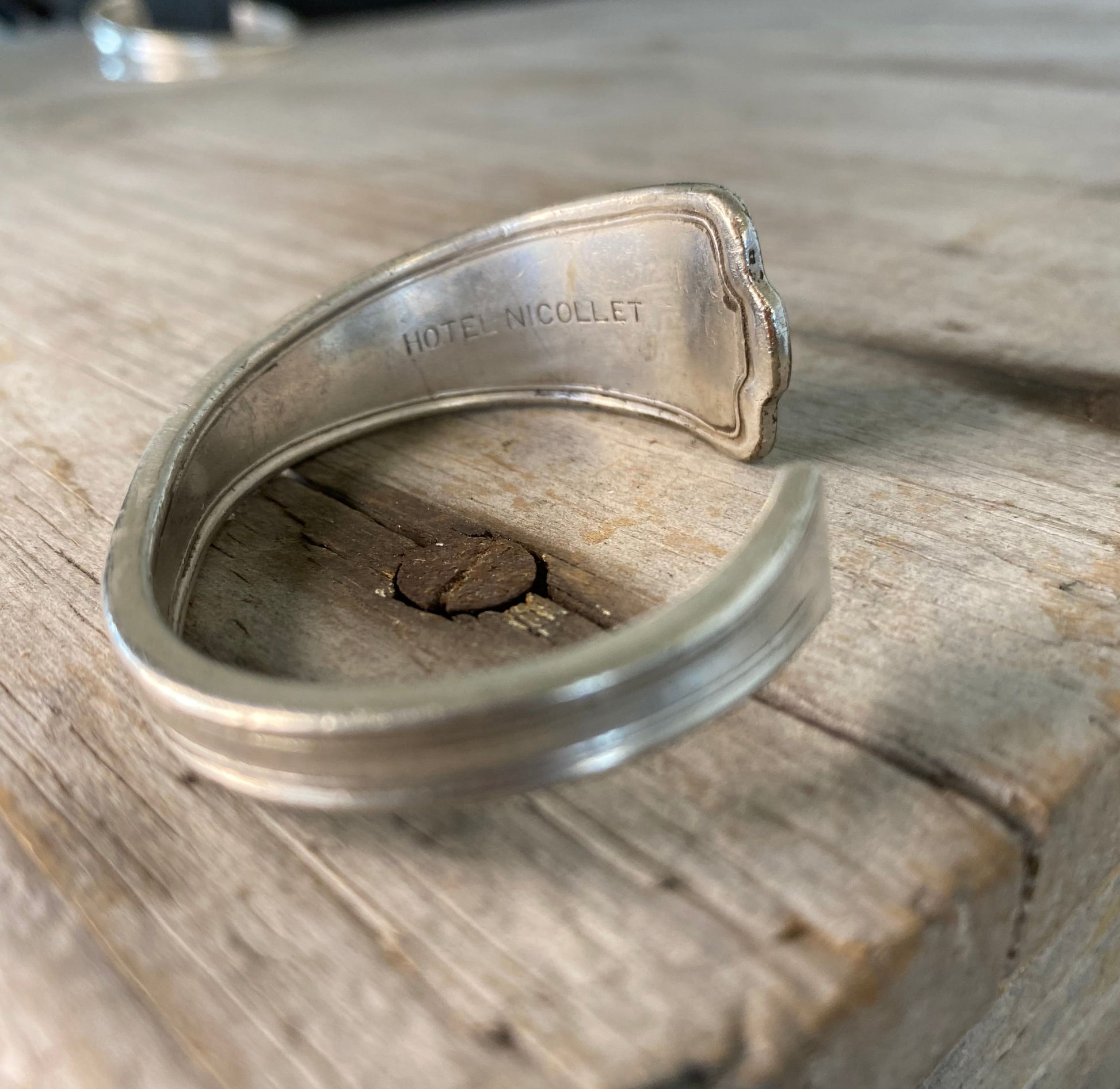 Close-up detail of internal Hotel Nicollet stamping on interior of spoon cuff bracelet