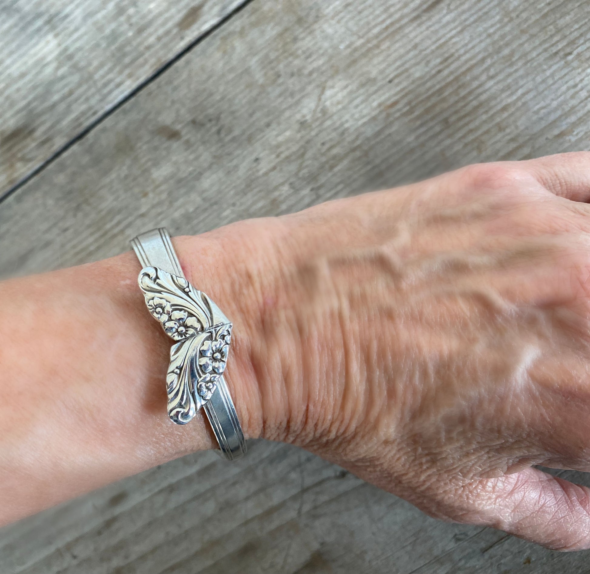 Heart-shaped spoon cuff bracelet made from upcycled Evening Star silverware pattern