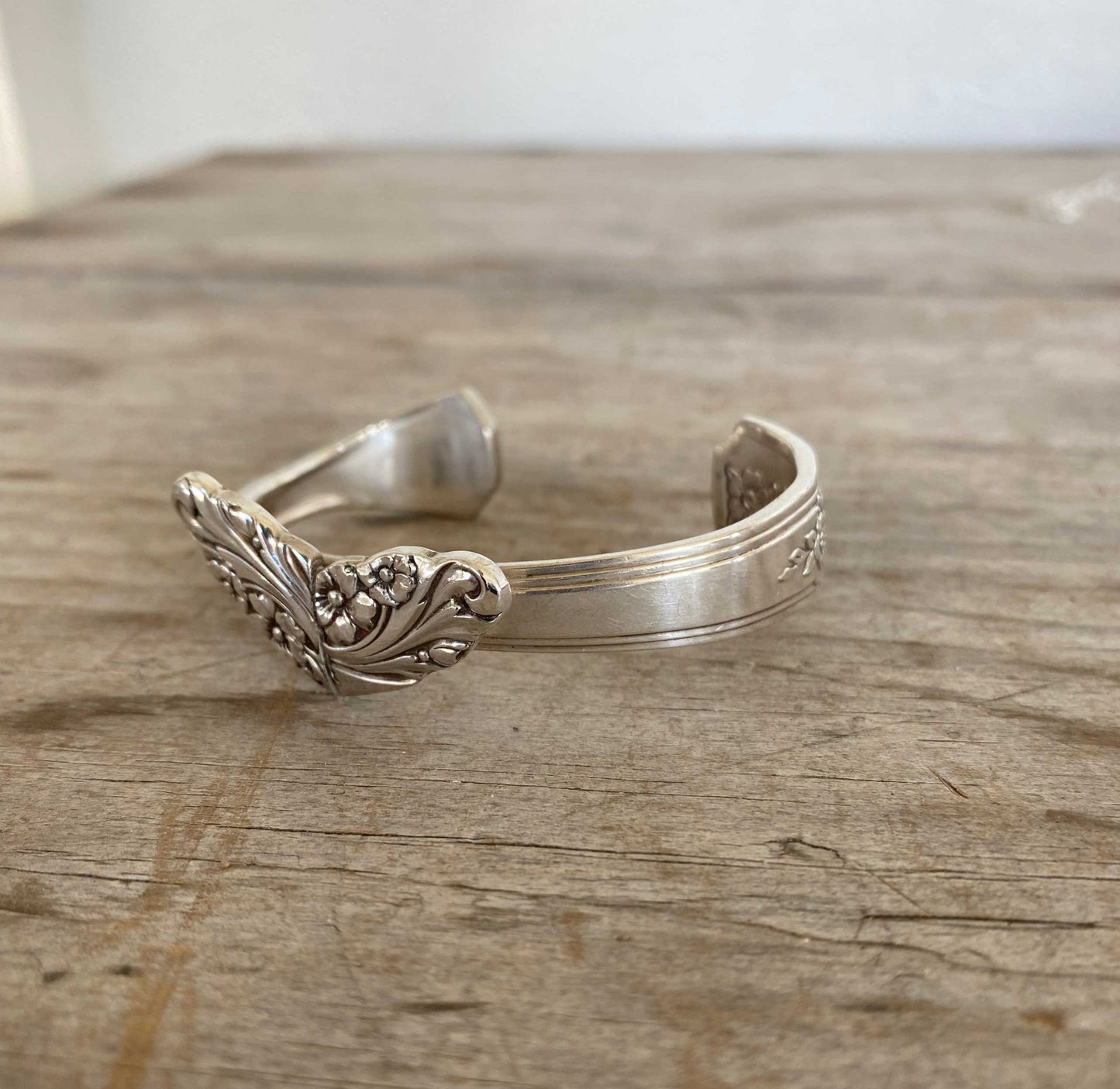 Side view of upcycled spoon heart cuff bracelet displaying artisan craftsmanship