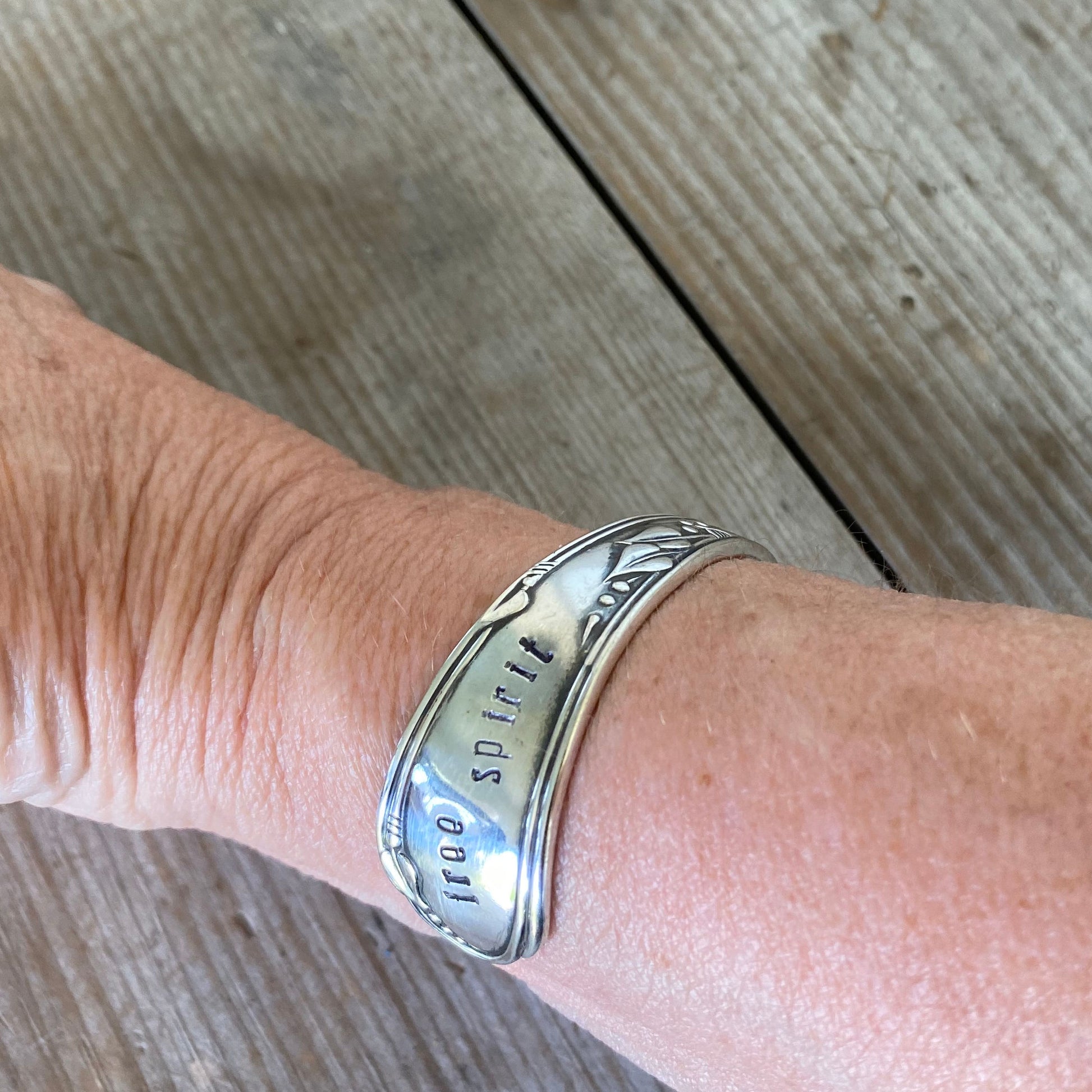 FREE SPIRIT hand-stamped spoon cuff bracelet shown on model wrist - vintage 1936 William A. Rogers silverplate with bohemian message