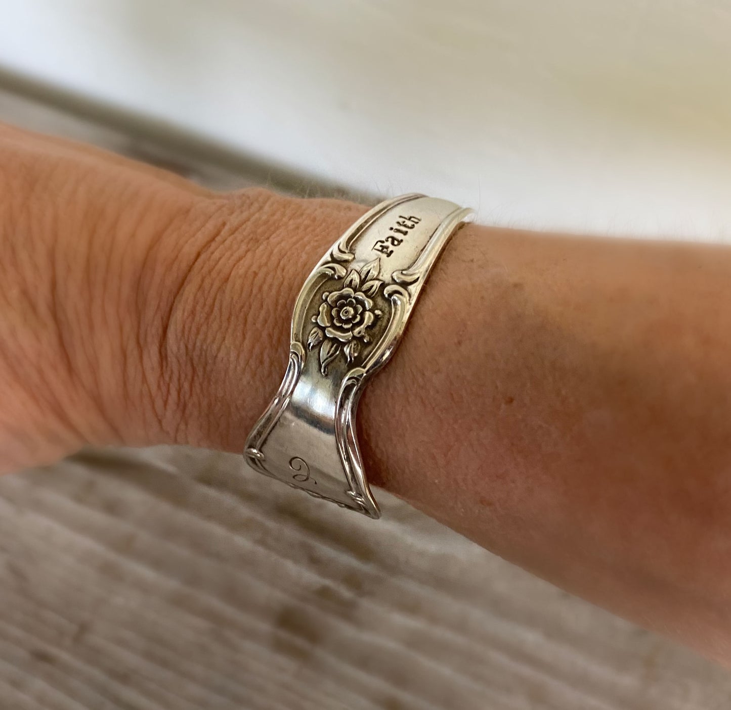 FAITH hand-stamped spoon cuff bracelet shown on model wrist - vintage 1950 Old Company Plate silverplate with inspirational message
