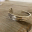 Hand-stamped spoon cuff bracelet from Old Company Plate Signature pattern with FAITH message and floral design
