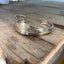 Top view of Upcycled silverware spoon cuff bracelet with hand stamped words FUCKITY FUCK FUCK