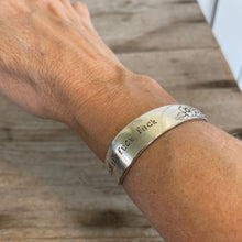 Upcycled silverware spoon cuff bracelet with handstamped words FUCKITY FUCK FUCK shown on model's wrist