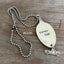 Detail of VINTAGE SOUL stamped spoon pendant showing hand-stamped lettering and vintage truck charm on upcycled silverware