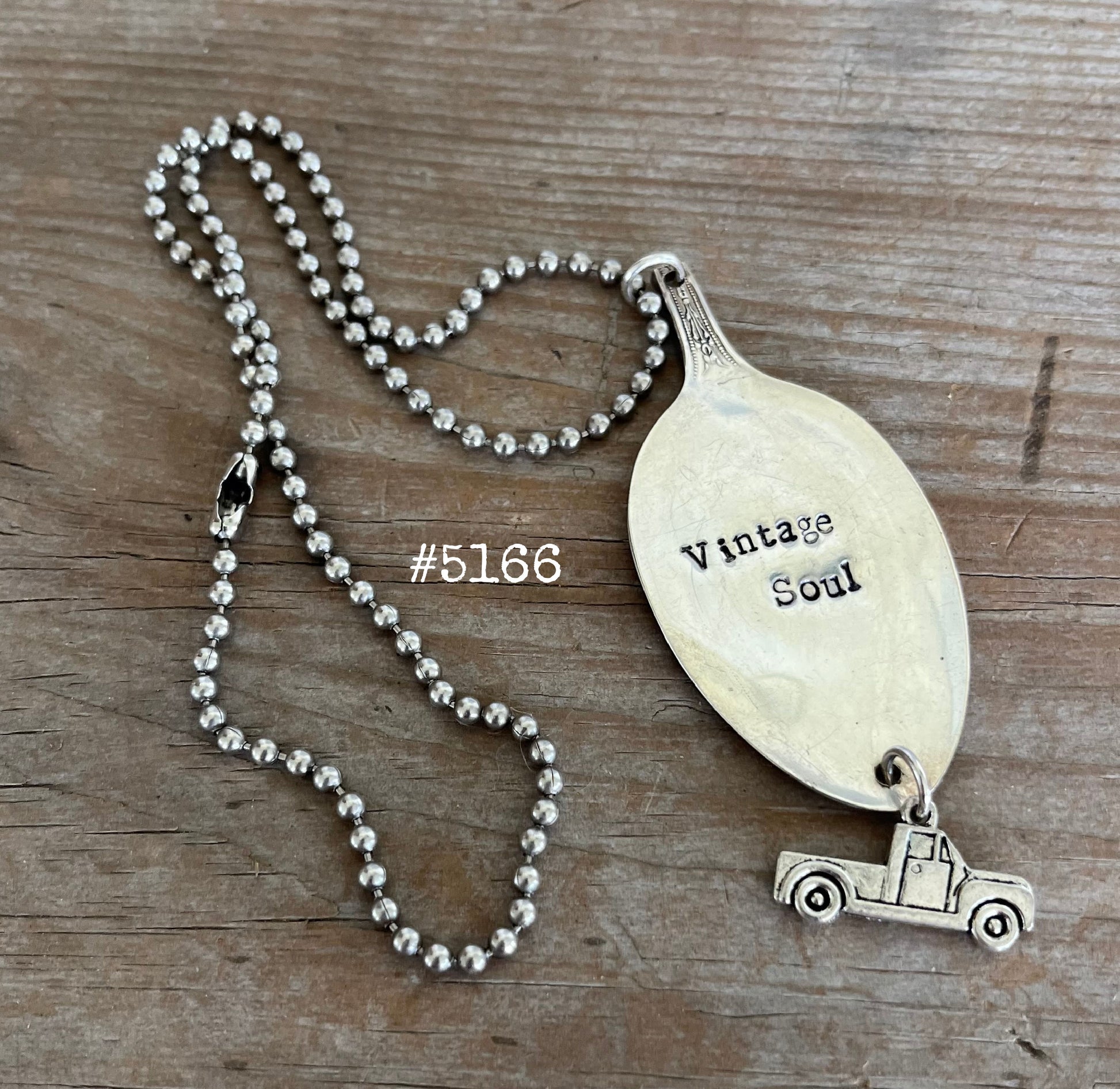 Detail of VINTAGE SOUL stamped spoon pendant showing hand-stamped lettering and vintage truck charm on upcycled silverware