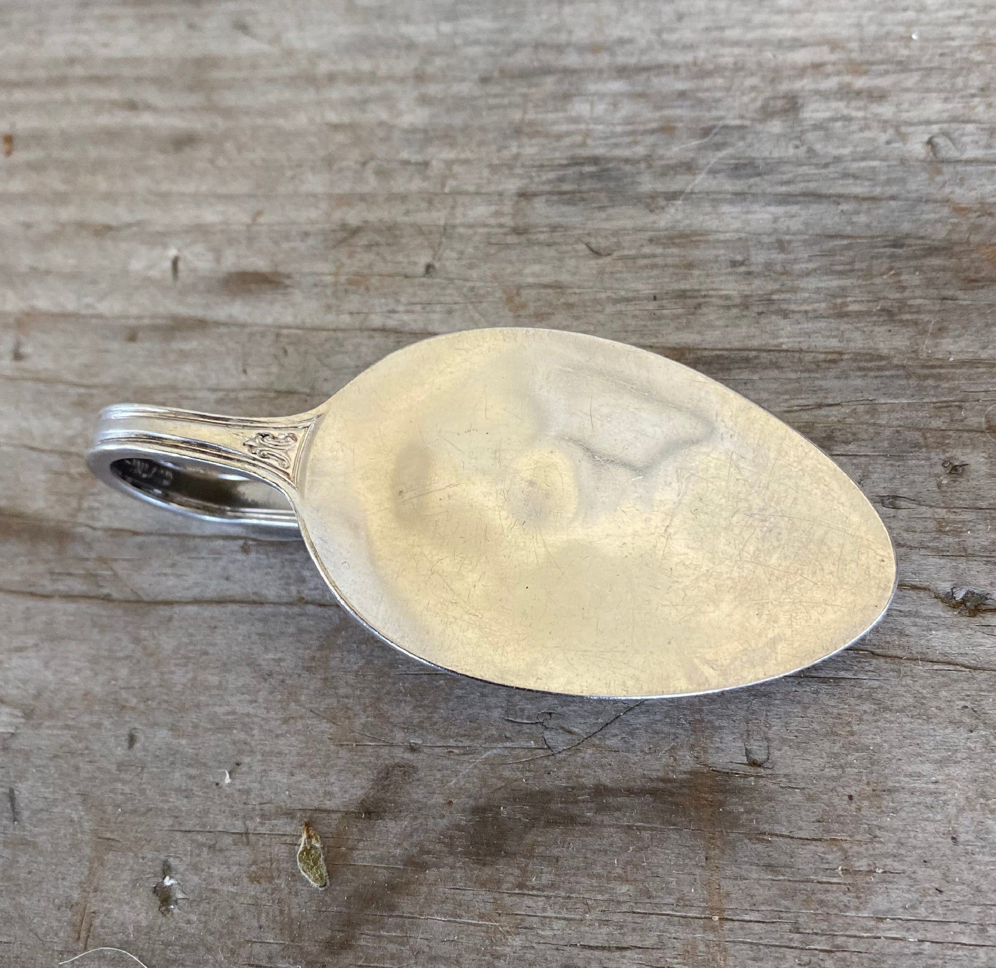 Back view of upcycled Century silverware money clip showing the actual spoon bowl