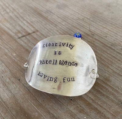 Hand-stamped vintage spoon bracelet with 'Creativity Is Intelligence Having Fun' Einstein quote and cobalt blue millefiori glass bead
