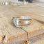 Close-up detail of REMEMBER hand-stamped spoon cuff bracelet showing Croydon/Mary Lee pattern and vintage silverplate