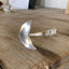 Close-up of sculpted Mermaid tail fin on vintage Lady Hamilton spoon cuff