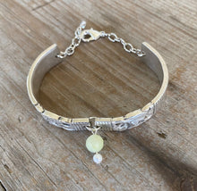 Top view of upcycled silverware jewelry spoon link bracelet with Peridot stone bead