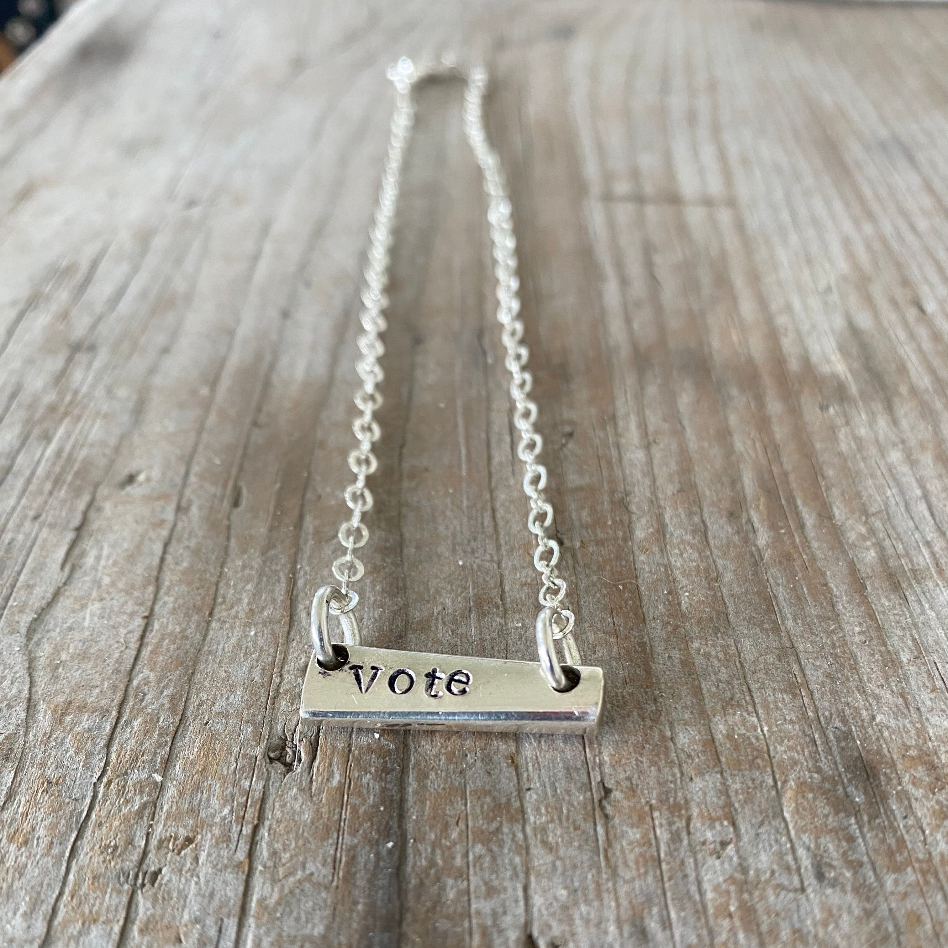 Handcrafted VOTE bar choker necklace hand-stamped on upcycled vintage silverplate with typewriter-style font, eco-friendly jewelry